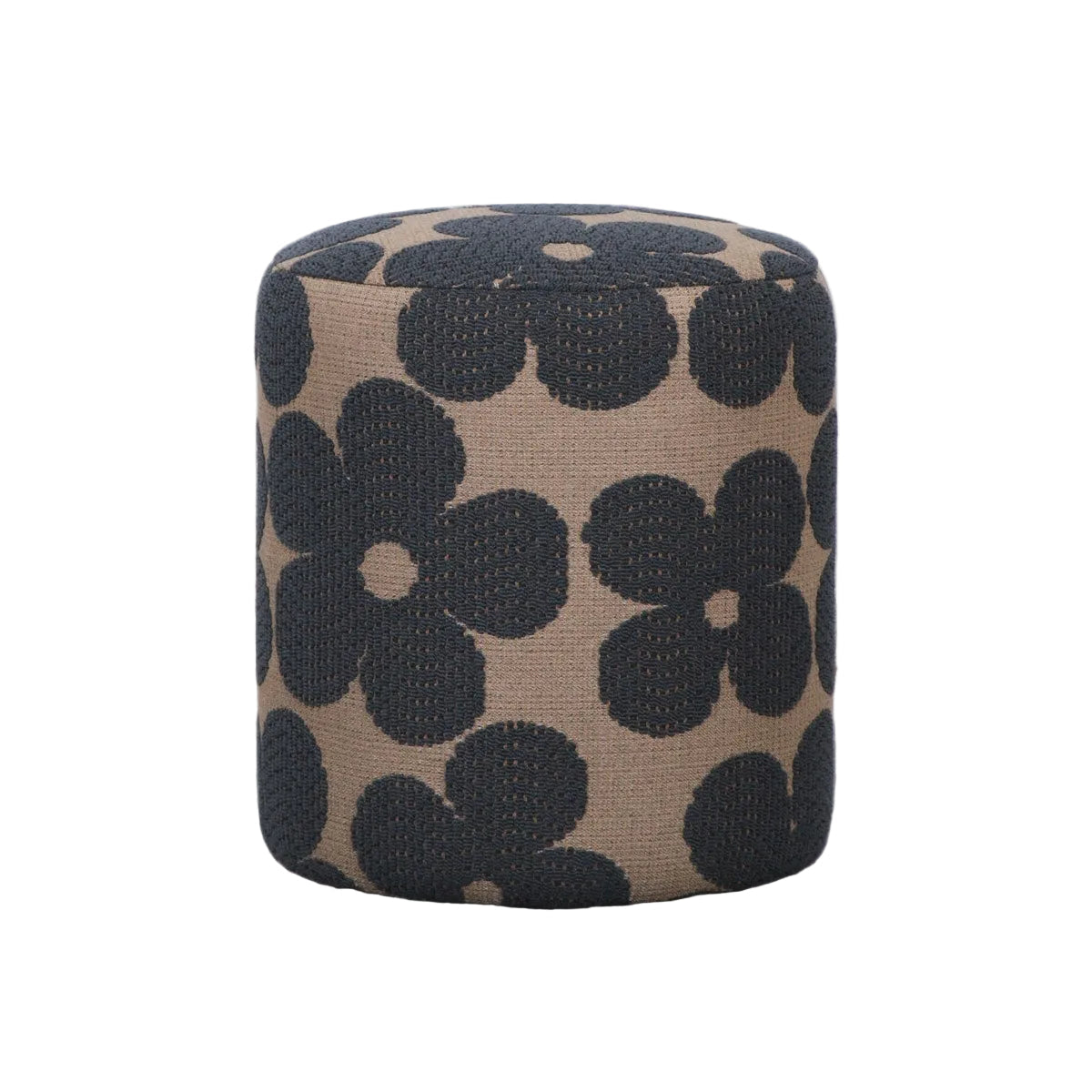 A cylindrical upholstered ottoman with a beige fabric base and large black floral pattern, standing on a gray concrete floor against a white wall.